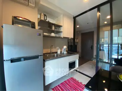 Modern kitchen with sleek appliances and open shelving in stylish apartment
