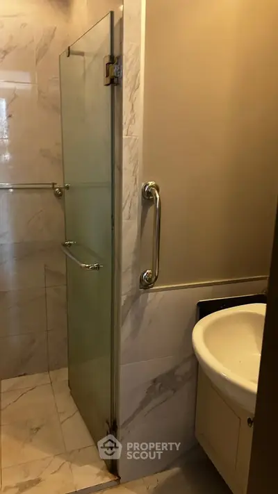 Modern bathroom with glass shower door and sleek sink design