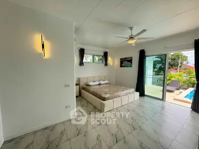 Spacious bedroom with pool view and modern decor in luxury home