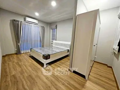 Spacious bedroom with modern design and wooden flooring