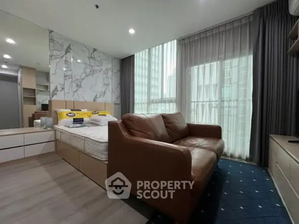 Modern studio apartment with cozy living area and stylish decor