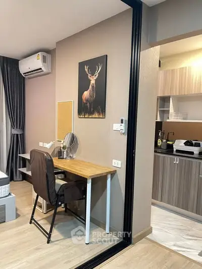 Modern apartment interior with study area and kitchen, featuring stylish decor and efficient use of space.