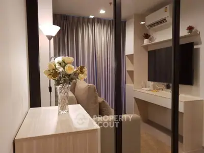 Modern living room with elegant decor and cozy ambiance, featuring a stylish sofa and wall-mounted TV.