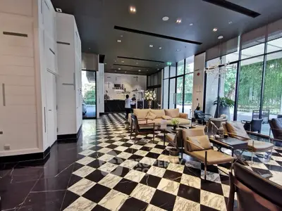 Luxurious modern living room with elegant black and white flooring and stylish furniture.
