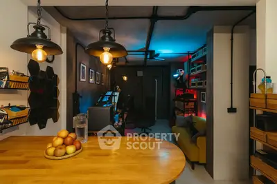 Modern industrial-style living room with cozy lighting and wooden accents.