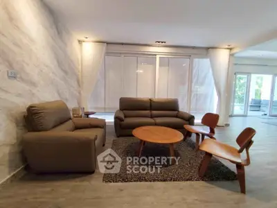 Spacious living room with modern furniture and large windows for natural light.