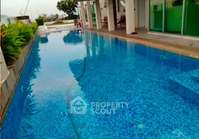 Luxurious private pool with modern design and lush greenery, perfect for relaxation and entertainment.