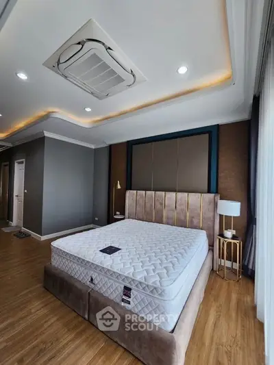 Luxurious bedroom with modern ceiling design and elegant furnishings.