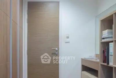 Modern interior with wooden door and built-in shelving, perfect for stylish living.