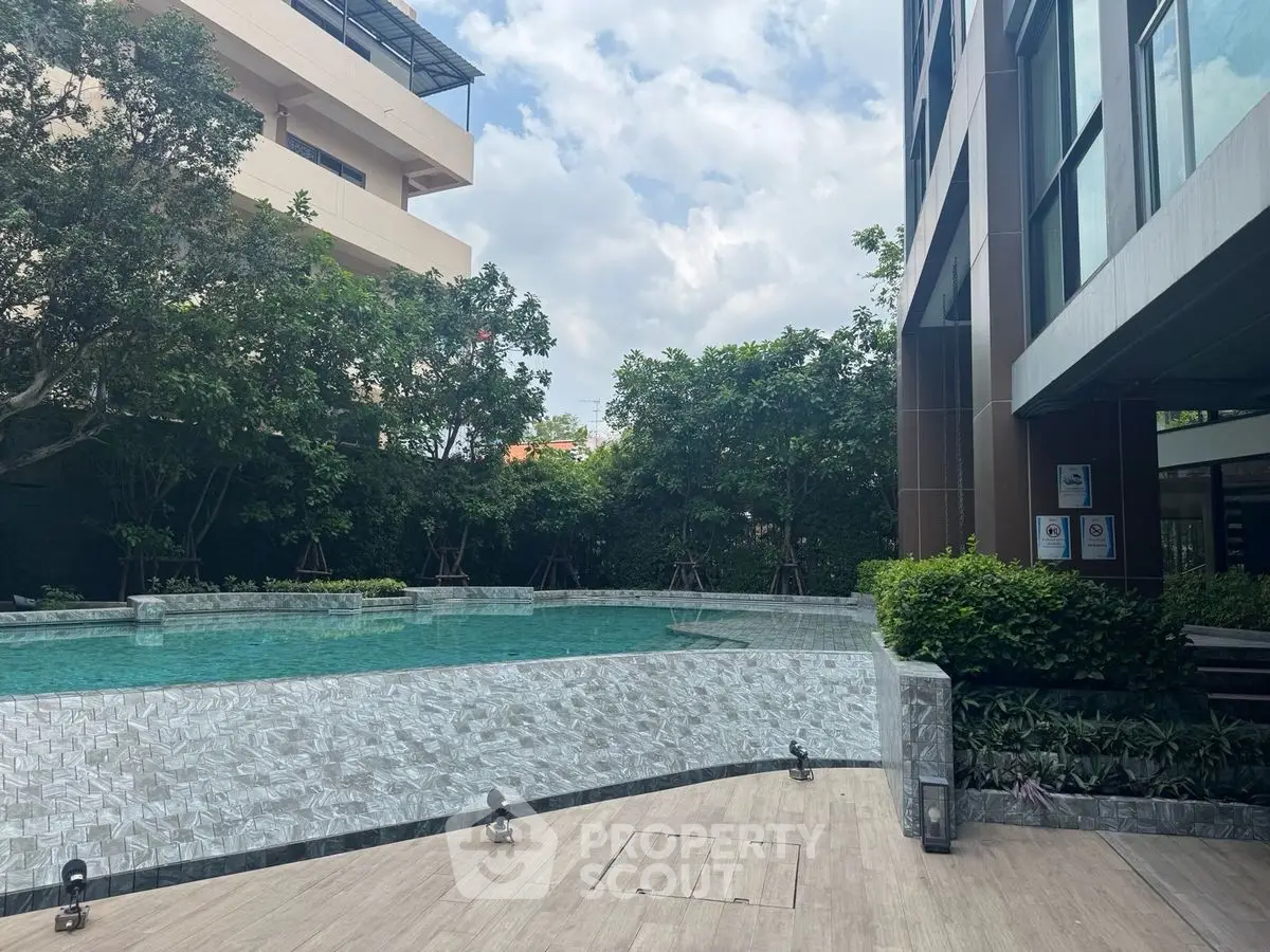 Luxurious outdoor pool area with lush greenery and modern architecture