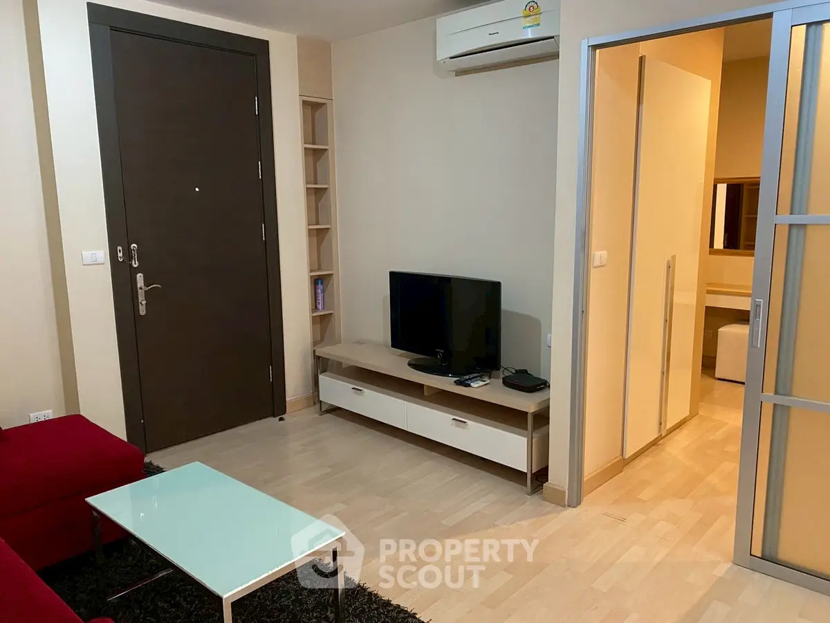 Modern living room with sleek furniture and air conditioning in a cozy apartment.