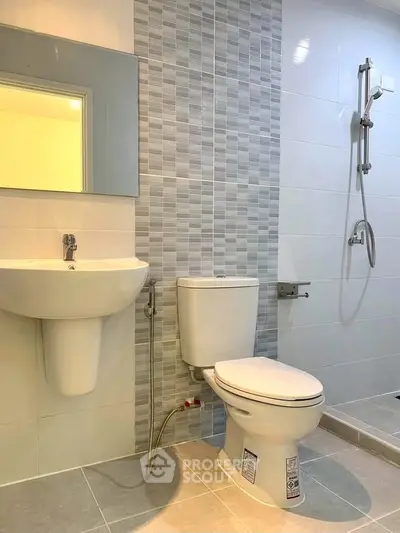 Modern bathroom with sleek fixtures and stylish tile design.