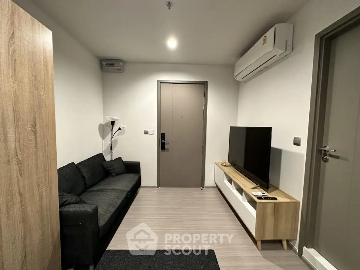 Modern living room with sleek furniture and wall-mounted TV