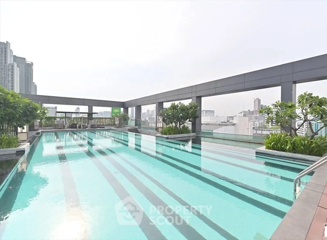 Luxurious rooftop pool with city skyline views and lush greenery