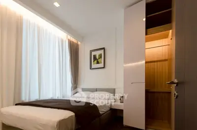 Modern bedroom with cozy bed and open closet in stylish apartment