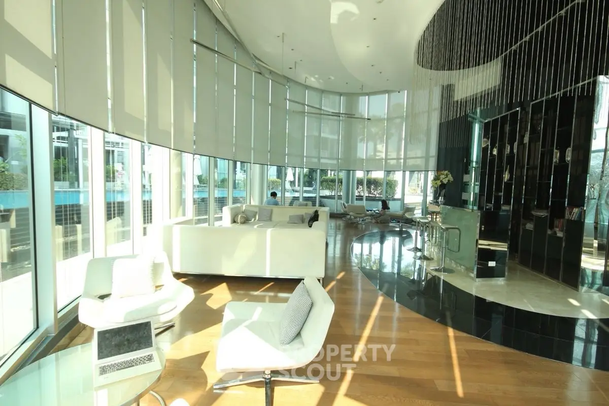 Luxurious modern living room with floor-to-ceiling windows and elegant furnishings