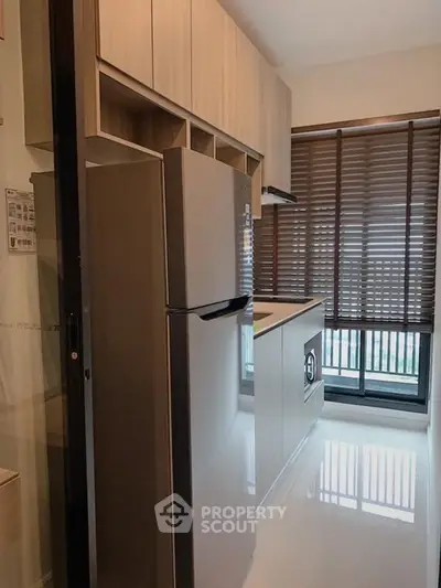 Modern kitchen with sleek appliances and large window for natural light