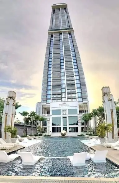 Luxurious high-rise building with stunning pool and modern architecture.