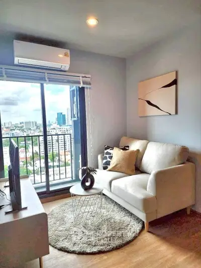 Modern living room with city view, cozy sofa, and stylish decor in a high-rise apartment.