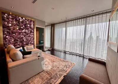 Luxurious living room with floor-to-ceiling windows and elegant decor in high-rise apartment.
