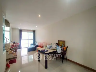 Spacious living room with modern decor and ample natural light