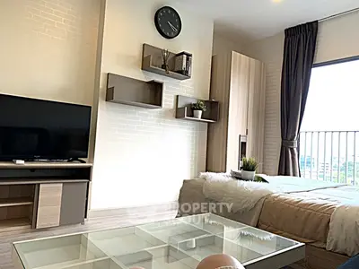 Modern bedroom with stylish decor and balcony view, featuring sleek furniture and cozy ambiance.