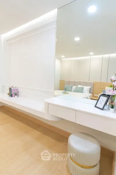 Elegant bedroom with modern vanity and plush decor, perfect for a serene retreat.