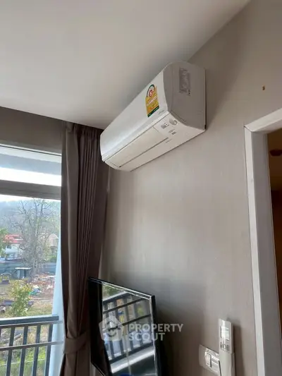 Modern apartment interior with air conditioning and large window view