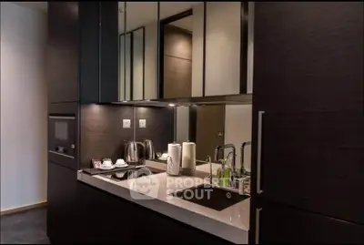 Modern kitchen with sleek cabinetry and built-in appliances in a stylish apartment.