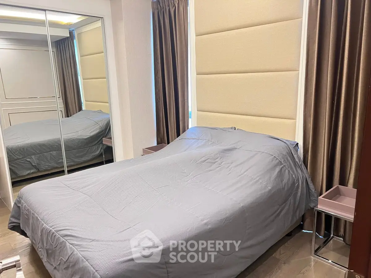 Cozy bedroom with mirrored closet and elegant curtains