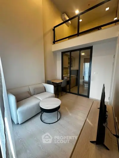 Modern loft-style living room with high ceiling and sleek furniture