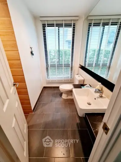 Modern bathroom with large window and sleek design