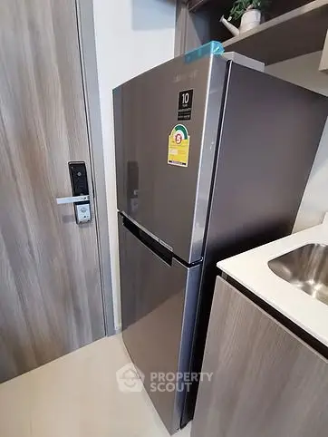 Modern kitchen with sleek stainless steel refrigerator and stylish cabinetry