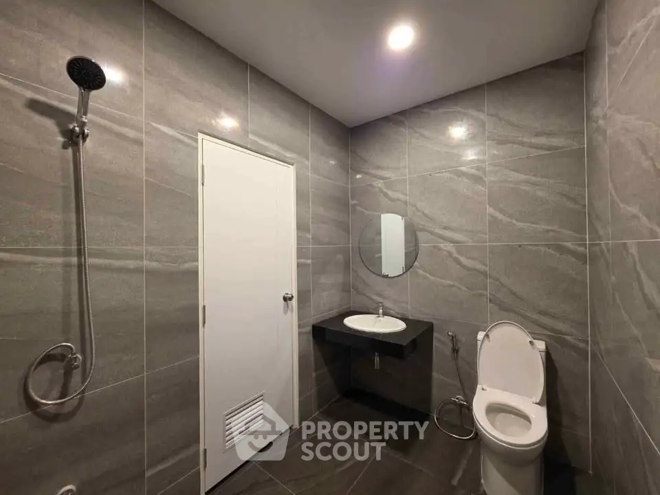 Modern bathroom with sleek gray tiles and minimalist fixtures