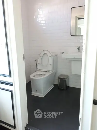 Modern bathroom with sleek white tiles and contemporary fixtures