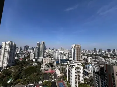 Stunning cityscape view from high-rise apartment balcony showcasing urban skyline.