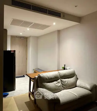 Cozy living room with modern furniture and dining area in a stylish apartment.