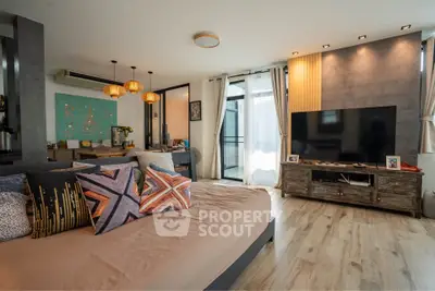 Spacious modern living room with stylish decor and large TV