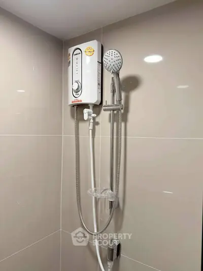 Modern bathroom with sleek shower and water heater installation.