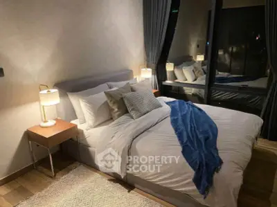 Luxurious bedroom with modern decor and large window offering stunning night views.