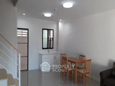 Modern open-plan living room with dining area and minimalist kitchen design