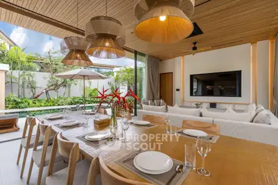 Luxurious open-plan living and dining area with garden view, featuring elegant wooden decor and modern furnishings.