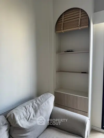 Cozy living room corner with modern shelving and comfortable sofa