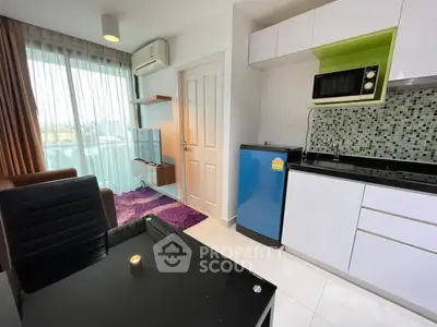 Modern studio apartment with kitchenette and city view, featuring sleek furniture and vibrant decor.