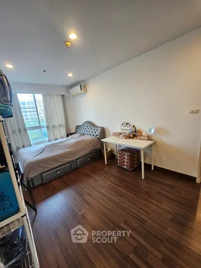 Spacious bedroom with elegant decor and natural light