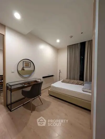 Modern bedroom with sleek design, featuring a cozy bed, stylish desk, and elegant decor in a bright, inviting space.