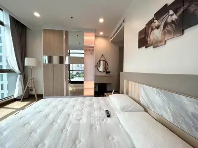 Spacious modern bedroom with large windows and stylish decor in a high-rise apartment.