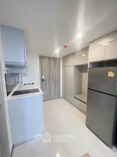 Modern kitchen with sleek cabinetry and stainless steel appliances in a compact layout.