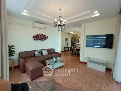 Spacious living room with elegant chandelier and modern decor