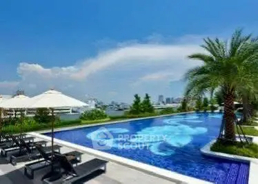 Luxurious rooftop pool with stunning city skyline view and palm trees.
